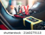 Charging electric power, energy to accumulator or dead battery in breakdown motorcycle for start. Include equipment tool i.e. portable trickle charger, positive negative clamp, red black cable wire.

