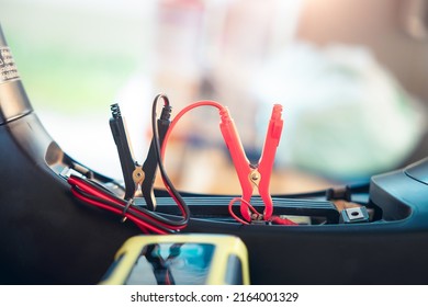 Charging electric power, energy to accumulator or dead battery in breakdown motorcycle for start. Include equipment tool i.e. portable trickle charger, positive negative clamp, red black cable wire.
				