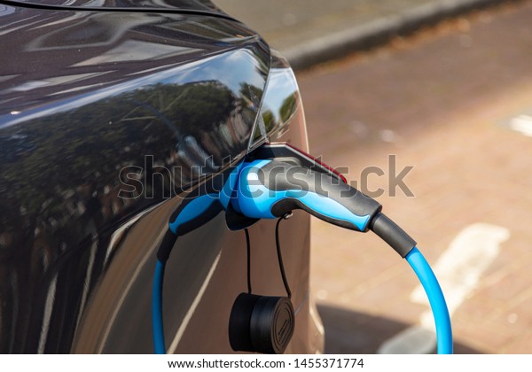 Charging the electric vehicle battery . EV fuel Plug\
in hybrid car close up\
view