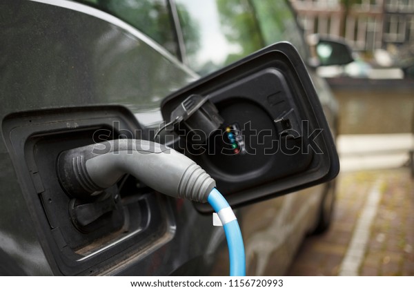 Charging electrical car on electric vehicle\
charging station.