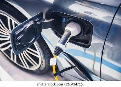 charging EV car electric vehicle clean energy for driving future - Shutterstock ID 2104247165
