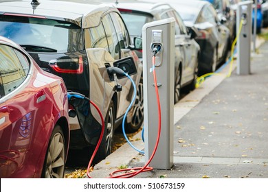 Charging modern electric cars (new energy vehicles, NEV) on the street station - Shutterstock ID 510673159