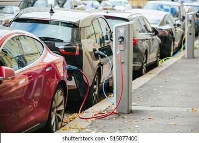 Charging modern electric cars (new energy vehicles, NEV) on the street station - Shutterstock ID 515877400