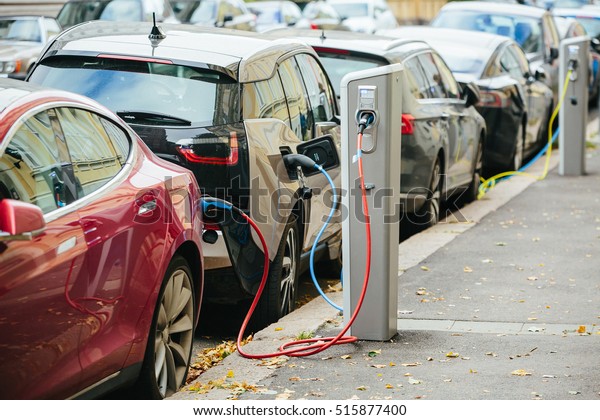 Charging modern electric cars (new energy\
vehicles, NEV) on the street\
station