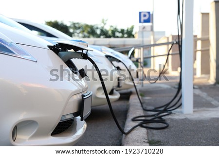 Charging modern electric cars from station outdoors