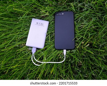 Charging Phone With Portable Charger.  Outdoor Camping, Picnic, Powerbank