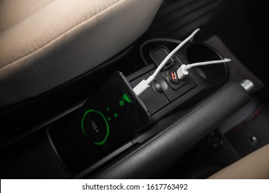 Charging Smartphone Battery With Usb Charger In The Car.