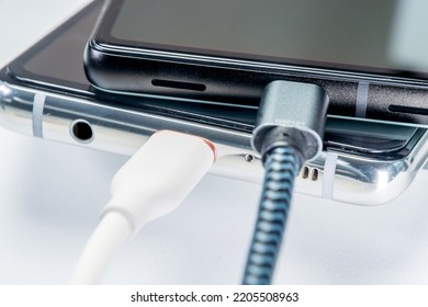 Charging smartphone. Close-up image. White background. - Shutterstock ID 2205508963