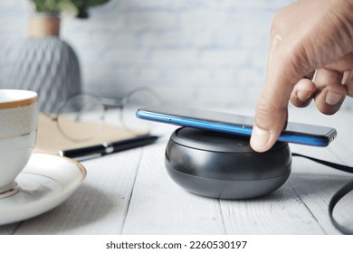charging Smartphone using Wireless Charging Pad, top view 
