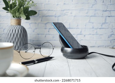 charging Smartphone using Wireless Charging Pad, top view 