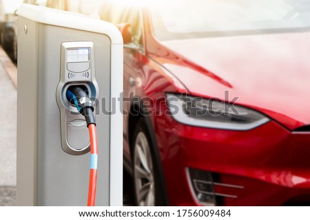 Charging station on the background of an electric car.