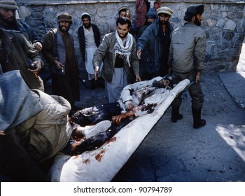 CHARIKAR, AFGHANISTAN - OCT 22: Mujaheddin fighters rush a Northern Alliance soldier to a hospital in Charikar, Afghanistan, on Wednesday, October 22, 1996.