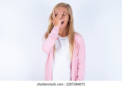 Charismatic Carefree Joyful Blonde Little Girl Wearing Pink Jacket And Glasses Over White Background Likes Laugh Out Loud Not Hiding Emotions Giggling Hear Funny Hilarious Joke Chuckling Facepalm.