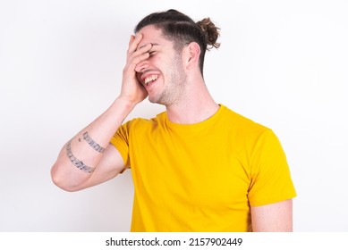 Charismatic Carefree Joyful Young Caucasian Man Wearing Yellow T-shirt Over White Background Likes Laugh Out Loud Not Hiding Emotions Giggling Hear Funny Hilarious Joke Chuckling Facepalm.