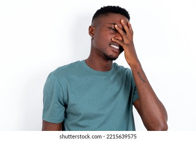 Charismatic Carefree Joyful Young Handsome Man Wearing Green T-shirt Over White Background Likes Laugh Out Loud Not Hiding Emotions Giggling Hear Funny Hilarious Joke Chuckling Facepalm.