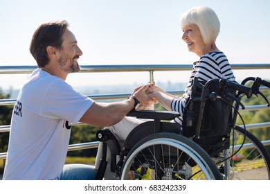 Charismatic creative volunteer supporting elderly lady - Shutterstock ID 683242339