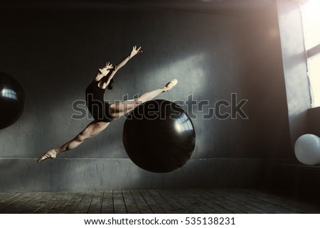 Similar – Rear view portrait of one young middle age athletic woman at crossfit training, exercising with trx suspension fitness straps over dark background