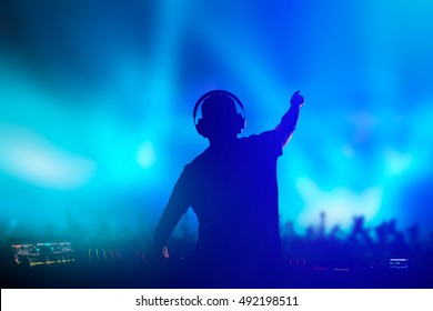 Charismatic disc jockey. Club, disco DJ playing and mixing music for crowd people.