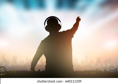 Charismatic disc jockey. Club, disco DJ playing and mixing music for crowd people.