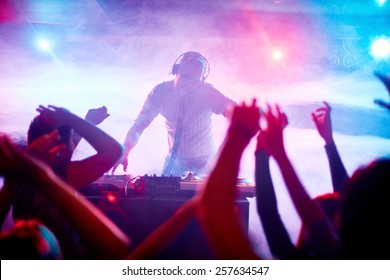Charismatic disc jockey at the turntable - Shutterstock ID 257634547