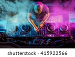 Charismatic disc jockey at the turntable. DJ plays on the best, famous CD players at nightclub during party. EDM, party concept.