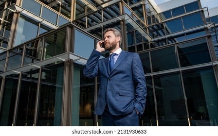 Charismatic Entrepreneur In Suit Has Phone Conversation Outside The Office, Modern Communication.