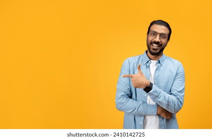A charismatic man with a beard and glasses smiles and points sideways with his left hand, giving an impression of friendliness and approachability against an orange backdrop