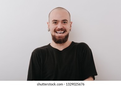 charismatic man smiles at the camera, isolated background gray, copy space, black shirt