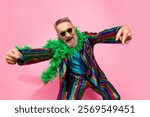 Charismatic older gentleman celebrating in a colorful disco suit against a pink backdrop