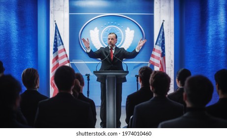 Charismatic Organization Representative Greeting Supporters at Conference in USA Government Building. Press Office Representative Delivering a Speech at a Summit. Minister Speaking to Congress. - Powered by Shutterstock