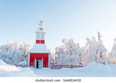 Charismatic Red Timber Jukkasjärvi Church In Swedish Lapland Covered With Snow