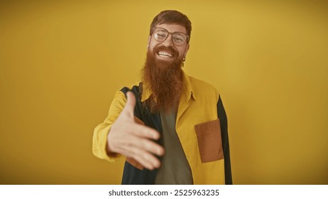 A charismatic young man with a beard and glasses extends a handshake against a vibrant yellow background. - Powered by Shutterstock