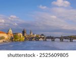 Charles Bridge (Karluv Most) on Vltava river and Old Town Bridge Tower, famous tourist destination in Prague, Czech Republic (Czechia), at sunset