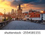 Charles Bridge in Prague at sunset. Prague, Czech Republic. Charles Bridge (Karluv Most) and Old Town Tower. Vltava River and Charles Bridge. Concept of world travel, sightseeing and tourism.