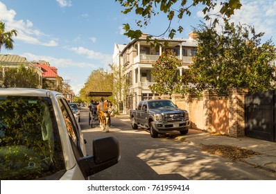 CHARLESTON, SC - OCT 03, 2017: Horse-drawn Carriage Pulling Tourists Through Narrow Streets And Historic Homes Of Charleston, South Carolina.