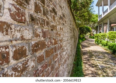 Charleston, SC, US-April 27, 2018: View Of Street With Iconic Brick Wall Constructed By Slaves In Historic District.