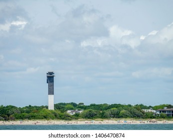 CHARLESTON, SC/USA - MAY 11, 2019: Lighthouse On Sullivan's Island, Commonly Known As Charleston Light, One Of The Most Modern Lighthouses In The U.S., Near A Popular Suburban Beach On The Ocean.