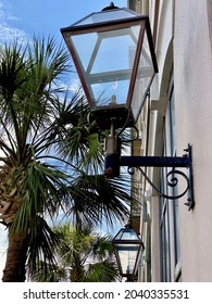 Charleston, South Carolina -2021: Gas lantern and palmetto tree. Both are symbols of the historic Carolina low country antebellum town. 