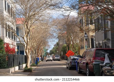 Charleston, South Carolina, USA Dec 28 2021: unknown pastel antebellum houses in Charleston, a port, holy city founded in 1670. It is also famous for its cobblestone streets, horse-drawn carriages.