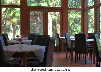 CHARLESTON, SOUTH CAROLINA, USA – JULY 28: Restaurant tables and chairs with bright sunlight from large windows at Middleton Place Restaurant in Charleston, South Carolina on July 28, 2015.