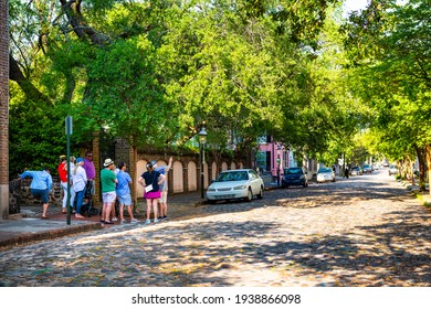 Charleston, USA - May 12, 2018: South Carolina Southern Downtown Old Town French Quarter City With People On Guided Walking Tour On Cobblestone Residential Street Road