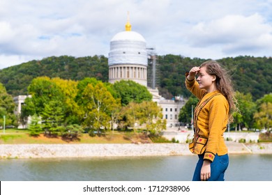 Charleston, West Virginia Capital City With Woman Looking At Scaffold Construction On State Capitol Dome From University Grounds By River