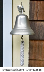 Charlestown, RI/USA - August 21, 219: A Vertical Image Of A Ship Captain's Dinner Bell, Mounted On The Back Door Of A Vintage Seaside Cottage.