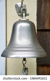 Charlestown, RI/USA - August 21, 219: A Vertical Image Of A Ship Captain's Dinner Bell, Mounted On The Back Door Of A Vintage Seaside Cottage.