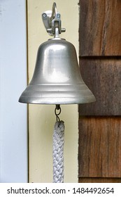 Charlestown, RI/USA - August 21, 219: A Vertical Image Of A Ship Captain's Dinner Bell, Mounted On The Back Door Of A Vintage Seaside Cottage.