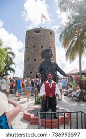 CHARLOTTE AMALIE, ST. THOMAS, US VIRGIN ISLANDS, December 8, 2015: Tour guide standing in front of the Blackbeard's statue at the historic Blackbeard's Castle