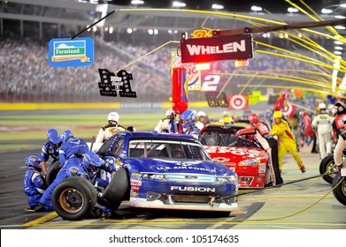 CHARLOTTE, NC - MAY 27:   Pit Stops For Aric Almirola (blue) And Tony Stewart At The Nascar Coca Cola 600  At Charlotte Motorspeedway In Charlotte, NC On May 27, 2012