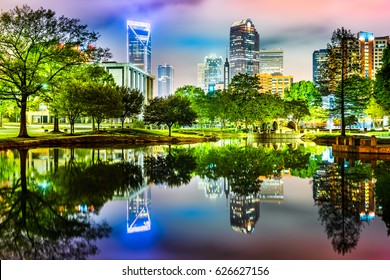Charlotte, NC skyline reflected in Marshall Park pond on a foggy night