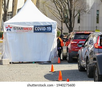 Charlotte, NC USA - March 20,  2021: The waiting line to receive the covid--19 vaccination from Starmed healthcare outside Bojangles Coliseum. Starmed vaccinates hundreds of people everyday.
