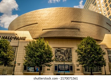 Charlotte, NC USA - May 26, 2019:  Horizontal, medium shot of exterior, back side, facade of the "NASCAR Hall of Fame" racing museum's distinctive building architecture near sunset with sky.